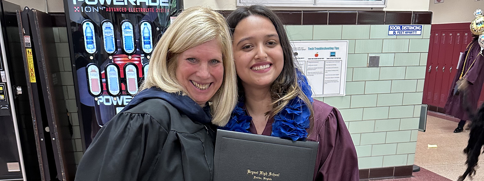 Bryant High School Counselor Margaret Veenstra hugs new graduate Anyeli Salguero.