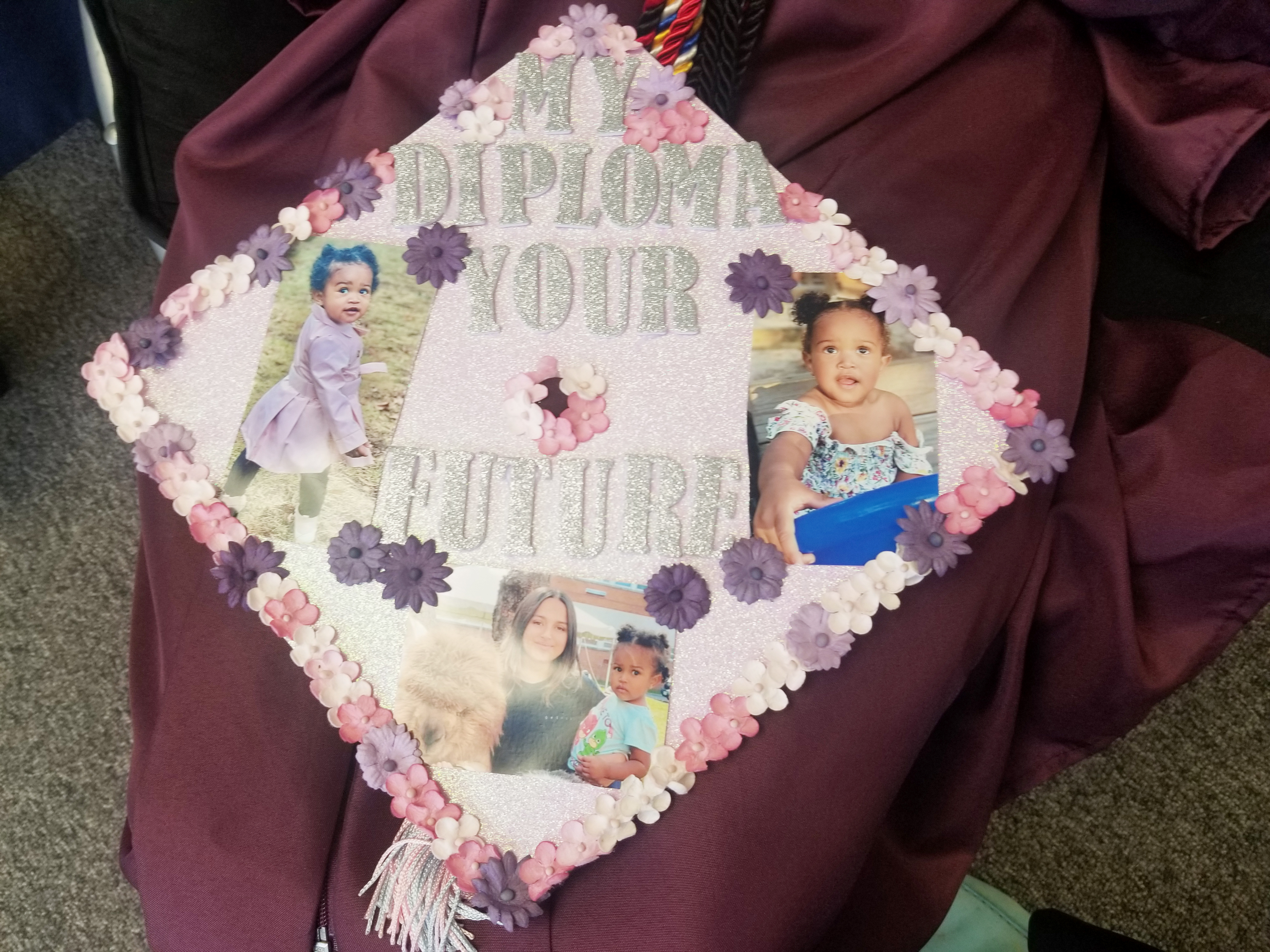 Anyeli's graduation cap displays photos of her daughter and says "My diploma, your future."